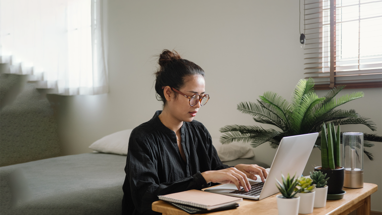 Woman learning online with laptop.