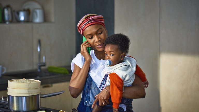 Woman with baby son in kitchen Woman with baby son in kitchen