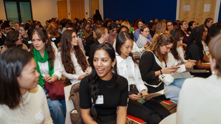 Auditorium of women talking. 