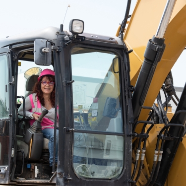 Woman working construction equipment