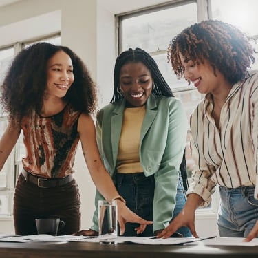 Teamwork, collaboration and planning black women with documents, paperwork or design strategy in office.