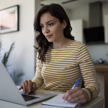 Young woman working at home on a laptop.